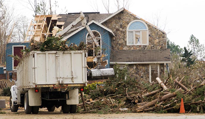 removing tree from tornado damaged house in Sandpoint, Pinehurst, ID